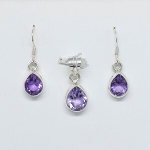 May include: A set of sterling silver earrings and a pendant featuring a teardrop-shaped amethyst gemstone. The earrings have a simple hook closure. The pendant has a bail for attaching to a chain.