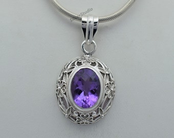 May include: A silver pendant with an oval amethyst gemstone set in a floral design.