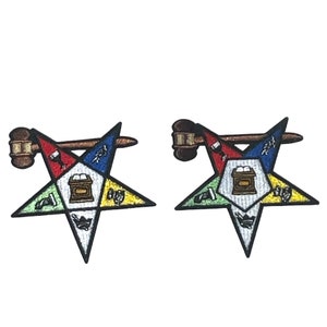 May include: Two embroidered patches featuring a five-pointed star with a gavel and other symbols. The star is divided into five sections, each a different color: red, blue, yellow, green, and white. The star is surrounded by a black outline.