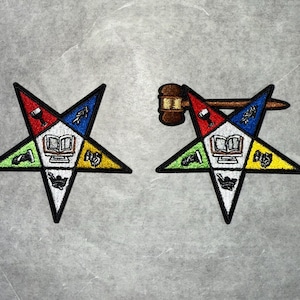 May include: Two embroidered patches featuring a five-pointed star with a variety of symbols inside. The star is red, yellow, green, blue, and white. The symbols include a book, a cup, a trowel, a plumb bob, and a sprig of acacia. One patch has a gavel and a wooden handle.