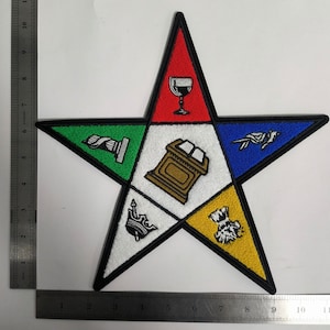 May include: A five-pointed star patch with a black outline and different colored sections. Each section features an embroidered symbol: a goblet, a column, a book on a stand, a crown, and a thistle.