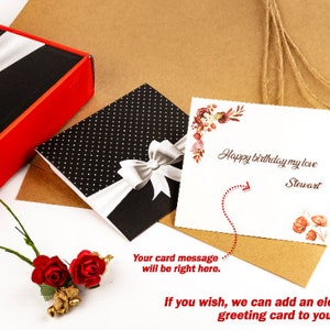May include: A white card with a floral design and the text "Happy birthday my love Stewart". The card is on a brown paper background with a black and white polka dot card and a red bow.