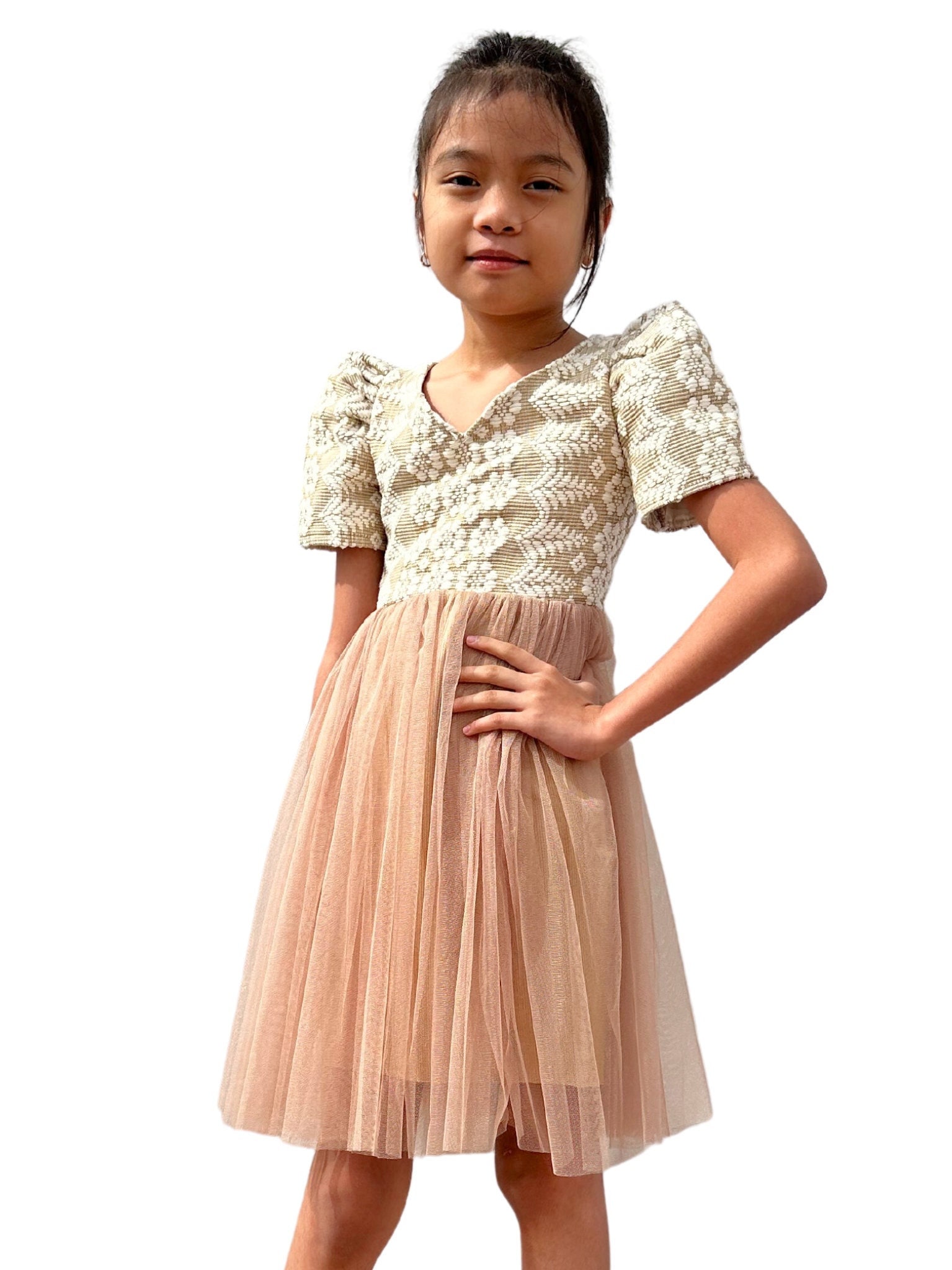 A young Filipina child sporting dress made of recycled col…