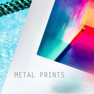 May include: A close-up of a colorful abstract metal print with a blue, green, pink, and orange color scheme. The text "METAL PRINTS" is visible at the bottom of the image.