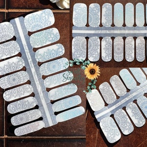 May include: A sheet of nail polish wraps with a mandala design in shades of blue and gray. The wraps are labeled "Sweet Serenity Nails" and "Mandala Dreams".