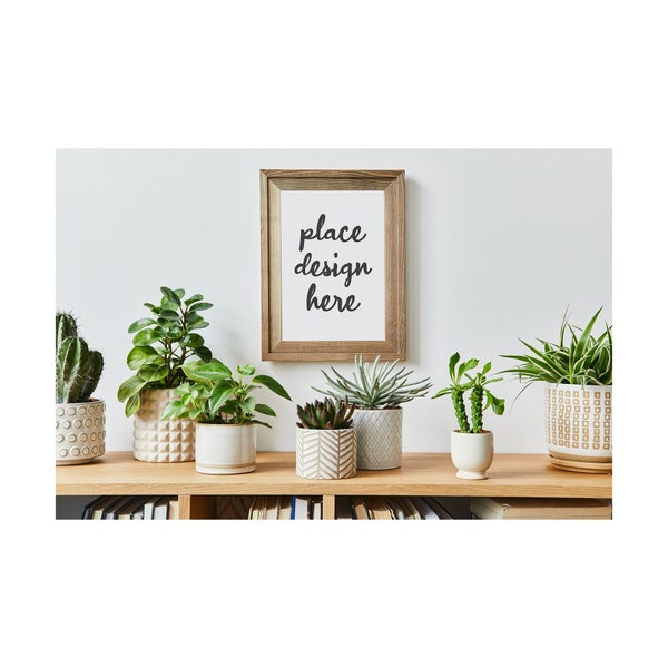 Creative composition of stylish room interior with mock up poster frame, wooden commode, plants in hipster pots and accessories.