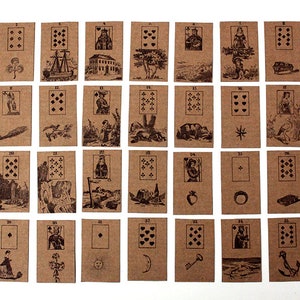 May include: A set of 36 brown playing cards with black ink illustrations. The cards are numbered 1 through 36 and feature various images, including a ship, a church, a tree, a bear, a star, a bird, a castle, a cliff, a bottle, a heart, a ring, a fish, an envelope, a key, an anchor, and a cross.