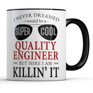 May include: White ceramic mug with a black interior and handle. The mug features the text "I NEVER DREAMED - I would be a - SUPER COOL QUALITY ENGINEER - BUT HERE I AM KILLIN' IT" in black and red font, with sunglasses graphic.