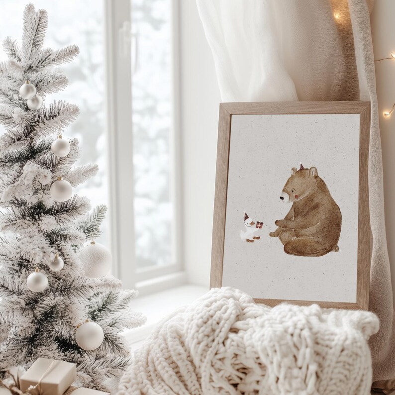 May include: A framed illustration of a brown bear sitting and looking at a small white rabbit with a red scarf. The illustration is on a beige background and is framed in a light brown frame.