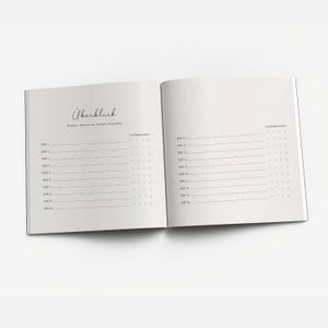May include: A white notebook with a black cover and a black spiral binding. The notebook has a section labeled "Overview" and a section labeled "Mood Tracker".
