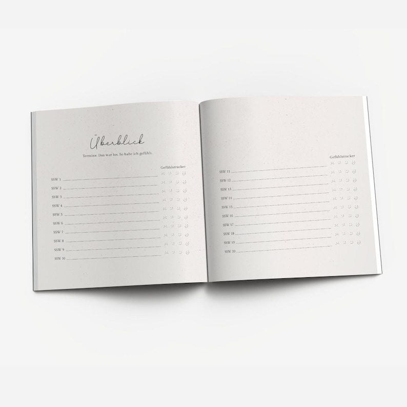 May include: A white notebook with a black cover and a black spiral binding. The notebook has a section labeled "Overview" and a section labeled "Mood Tracker".