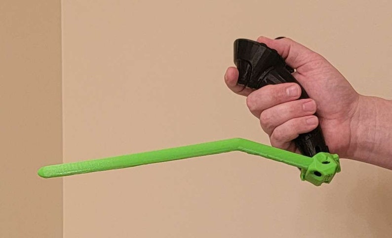 May include: A black and green 3D printed VR controller with a long green handle.
