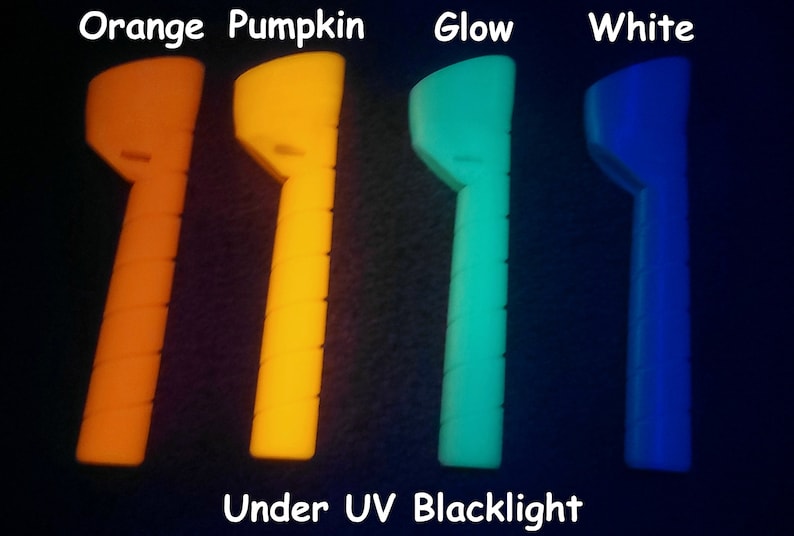 May include: Four glow sticks in different colors: orange, yellow, green, and blue. The glow sticks are under a UV blacklight.