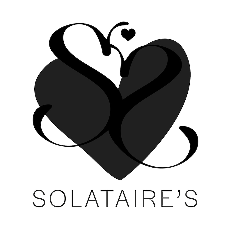 May include: Black and white logo with the text "SOLATAIRE'S" below. The logo features a stylized heart shape with a smaller heart at the top.