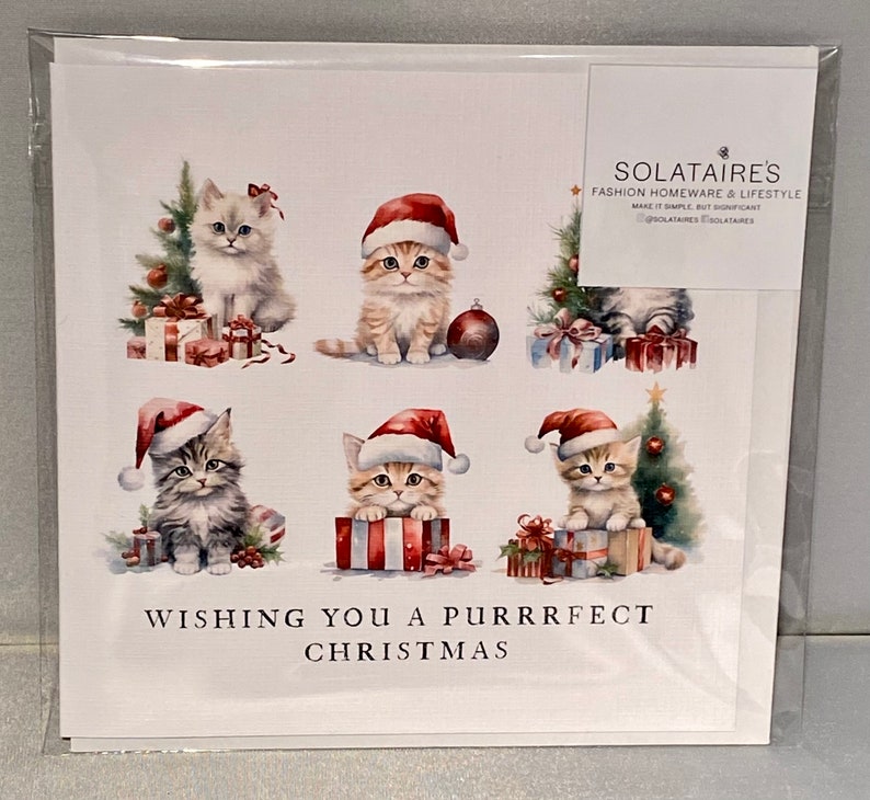 May include: A Christmas card featuring six adorable kittens wearing Santa hats. The kittens are surrounded by presents and Christmas trees. The card reads "Wishing you a purrrfect Christmas".