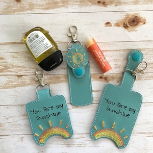 Sketchy Sunshine Essentials SnapTab Holder Set (1oz/2oz Sanitizer Holder, Lip Balm Holder) Digital Embroidery Design