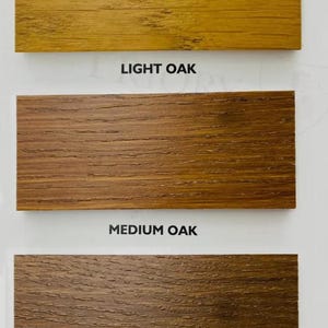 May include: Three wood samples showing different shades of oak: light oak, medium oak, and dark oak.