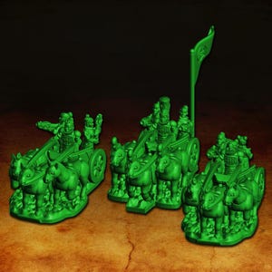 May include: Three green miniature chariot models, each pulled by a team of horses. The chariots have detailed figures of warriors and a flag. The models are set against a dark background.