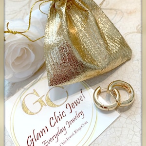 May include: Gold hoop earrings in a small gold pouch with a white tag that says "Glam Chic Jewel Everyday Jewelry GlamChicJewel.Etsy.com"