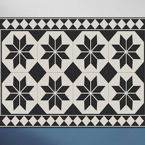 May include: Black and white patterned floor mat with a geometric design featuring eight-pointed stars. The mat has a black and white chequered border.