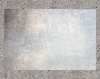 May include: A close-up of a light gray concrete wall with a rectangular, white, textured surface in the center.