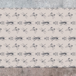 May include: Beige rectangular fabric with a repeating pattern of black insects. The pattern includes dragonflies, beetles, and ladybugs. The insects are evenly spaced across the fabric.
