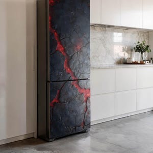 May include: A refrigerator with a dark gray and red lava design. The design covers the entire front of the refrigerator, with a cracked texture and a bright red, glowing pattern resembling lava flows. The appliance is in a modern kitchen.