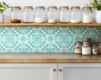 May include: A kitchen backsplash featuring a repeating teal and white damask pattern. The design consists of symmetrical floral and scroll motifs arranged in a grid. The backsplash is positioned behind a wooden shelf holding clear glass jars.