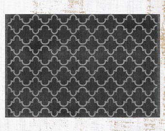May include: Black and white geometric patterned rug with a subtle distressed look. The pattern is a repeating design of interlocking quatrefoils.