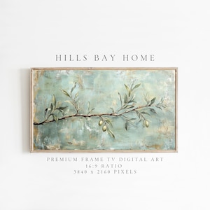 May include: A rectangular framed digital art print featuring a branch with olive leaves and olives against a textured, light blue and beige background. The text "HILLS BAY HOME" is at the top. Below the art is text that reads "PREMIUM FRAME TV DIGITAL ART 16:9 RATIO 3840 x 2160 PIXELS."