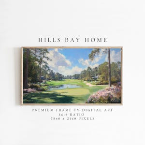 May include: A framed digital art print of a golf course landscape. The artwork features a green golf course with a pond, trees, and a blue sky with clouds. The text "HILLS BAY HOME" is at the top.