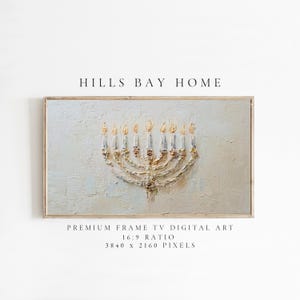 May include: A framed digital art print depicting a gold menorah with lit candles on a textured, pale blue backdrop. The text "HILLS BAY HOME" is at the top, with "PREMIUM FRAME TV DIGITAL ART" and dimensions below.