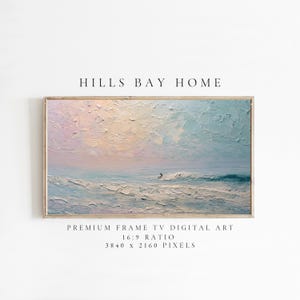 May include: A framed digital art piece with a coastal scene. The artwork features a surfer on a wave, with a sky of pink and blue hues. The text "HILLS BAY HOME" is at the top. The bottom text reads "PREMIUM FRAME TV DIGITAL ART 16:9 RATIO 3840 x 2160 PIXELS".