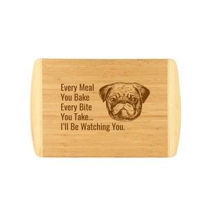 May include: A brown bamboo cutting board with a pug dog illustration and the text "Every Meal You Bake Every Bite You Take... I'll Be Watching You."