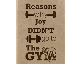 May include: A tan leather journal with the text "Reasons why Joy DIDN'T go to The GYM" and a cartoon sloth sleeping on the word "GYM".