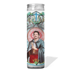 May include: A glass candle with a colorful image of a man with a beard and a crown, holding a key. The image is surrounded by a decorative border with a cross and flowers.