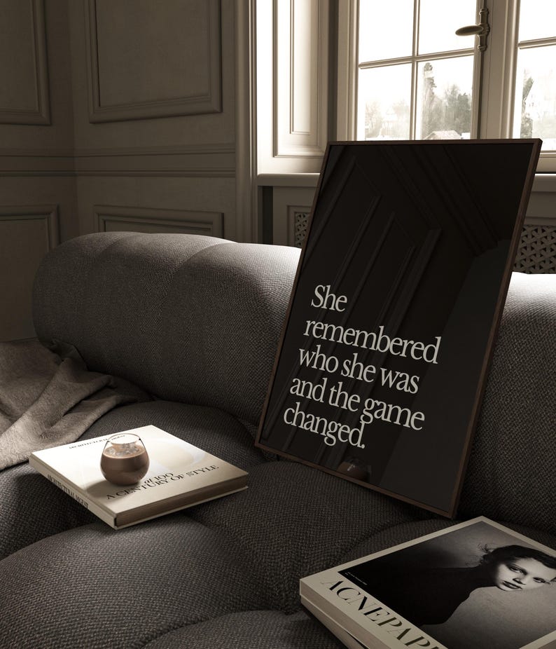 May include: A black and white framed print with the text "She remembered who she was and the game changed."