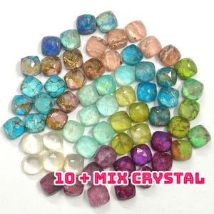 May include: A collection of faceted, square-shaped crystals in a variety of colors, including turquoise, pink, green, and purple. The text "10+ MIX CRYSTAL" is displayed in pink and white. The crystals are arranged on a white surface.