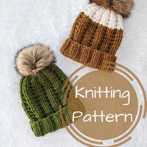 May include: Knitting pattern for two beanies with faux fur pom poms. One beanie is green and the other is brown and white.