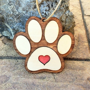 Wooden Paw Print Ornament. Hand crafted and laser engraved. 4" Diameter and 1/4" thick.