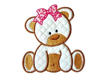 May include: White plush teddy bear with a pink bow, sitting with its legs crossed. The bear has brown embroidered eyes and a brown nose.