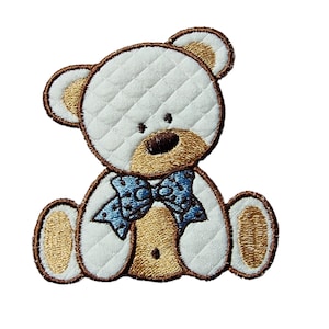May include: A white plush teddy bear with brown embroidered features, wearing a blue bow tie. The bear is sitting with its legs crossed and has a quilted texture.