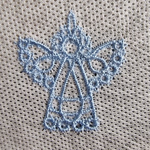 May include: A light blue embroidered angel design on a white mesh fabric.