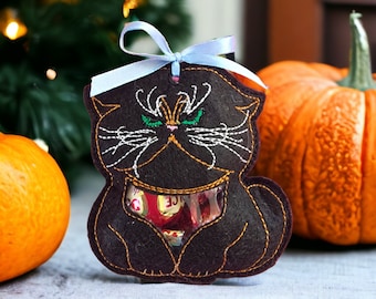May include: Black felt cat-shaped treat bag with a blue ribbon and a clear plastic window showing colorful candies inside.