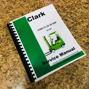 May include: A green and white Clark C500 forklift service manual with a green and white illustration of a forklift on the cover. The manual is titled "Service Manual" and has the model number "C500 (Y) 20 25 S30" and the part number "OH-367".