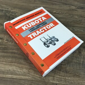 May include: A white and orange Kubota tractor workshop service manual for models L2250, L2550 (GST), L2850 (GST), and L3250. The manual has a silver title bar and brass rivets along the spine.