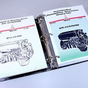 May include: Two open binders with workshop manuals for the B/FL 413 T/FR/FRW engine. The manuals are in English and German. The binders are black and have a silver ring mechanism.