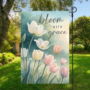 May include: A garden flag with a watercolor design of white and pink tulips. The text "bloom with grace" is printed on the flag.