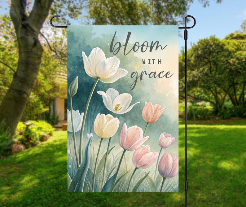 May include: A garden flag with a watercolor design of white and pink tulips. The text "bloom with grace" is printed on the flag.