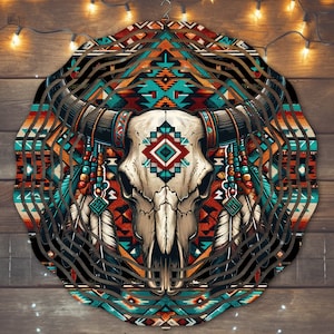 May include: A circular wooden wind chime with a Native American design featuring a bull skull, feathers, and geometric patterns in shades of red, blue, and brown.